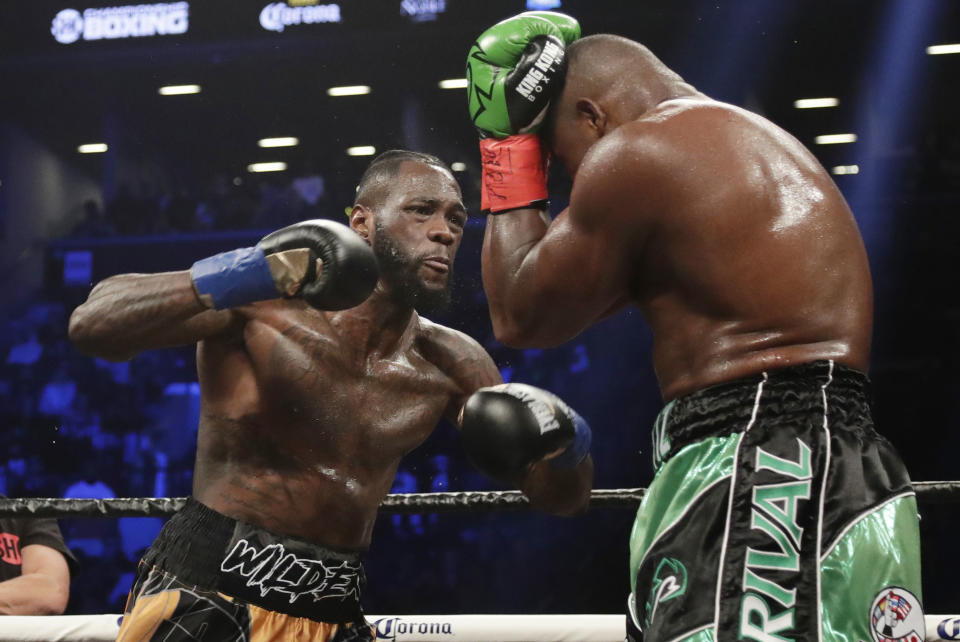 FILE - In this March 3, 2018, file photo, Deontay Wilder, left, fights Luis Ortiz during the third round of the WBC heavyweight championship bout in New York. Deontay Wilder and Anthony Joshua were once the main characters in heavyweight boxing’s soap opera but now they are extras. Wilder and Joshua are in the kingdom this weekend and fighting simply to stay relevant. (AP Photo/Frank Franklin II, File)