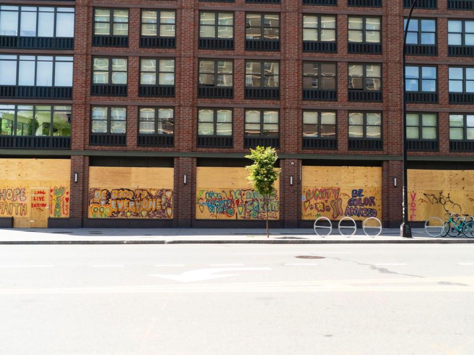 Street artists use boarded up buildings as canvases amid coronavirus closures and protests in the East Village on June 16, 2020 in New York City. (Photo by Gotham/Getty Images)