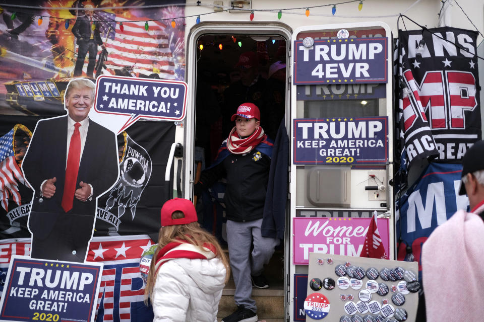 Trevor Horn, 12, checks out an RV full of President Donald Trump paraphernalia before the start of a rally in Wildwood, N.J., Tuesday, Jan. 28, 2020. (AP Photo/Seth Wenig)