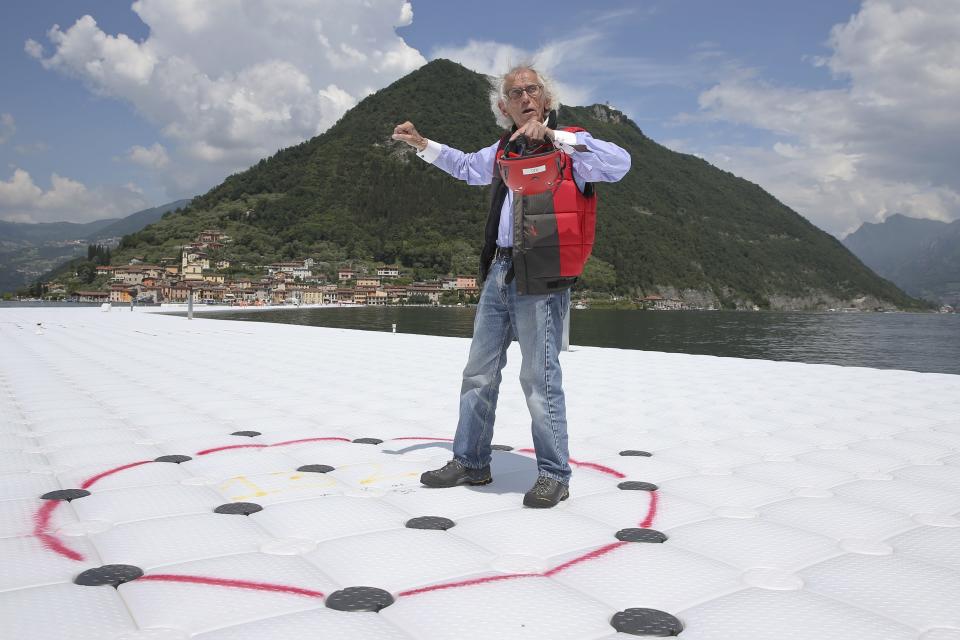 FILE - In this June 7, 2016, file photo, Bulgarian-born artist Christo Vladimirov Yavachev, known as Christo, gestures during an interview with the Associated Press on his installation 'The Floating Piers' on the Lake Iseo, northern Italy, Christo, known for massive, ephemeral public arts projects, has died. His death was announced Sunday, May 31, 2020, on Twitter and the artist's web page. He was 84. (AP Photo/Luca Bruno, File)