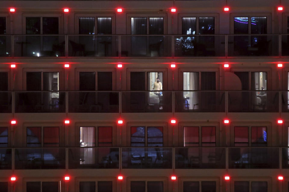 A worker cleans a cabin as passengers from the cruise ship World Dream docked at Kai Tak cruise terminal leave the ship after being quarantined for the coronavirus in Hong Kong, Sunday, Feb. 9, 2020. Several passengers from mainland China on a previous World Dream cruise were found to have the new coronavirus on returning home. (AP Photo/Kin Cheung)