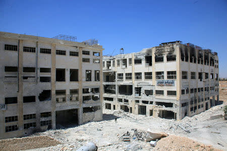 A member of forces loyal to Syria's President Bashar al-Assad stands amid damaged buildings after they advanced on the southern side of the Castello road in Aleppo, Syria, in this handout picture provided by SANA on July 28, 2016. SANA/Handout via REUTERS