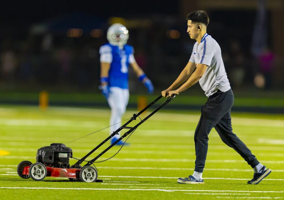 A prankster rolls an engine running lawn mower onto the field from the sidelines between plays in the third quarter between the Cedar Creek Eagles and the Bastrop Bears on Friday at Bastrop Memorial Stadium.