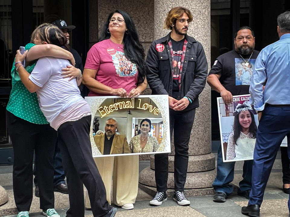 For a few minutes, during their break, the families rallied with Moms Demand Action, a gun regulation group, but none spoke.  (Suzanne Gamboa / NBC News)