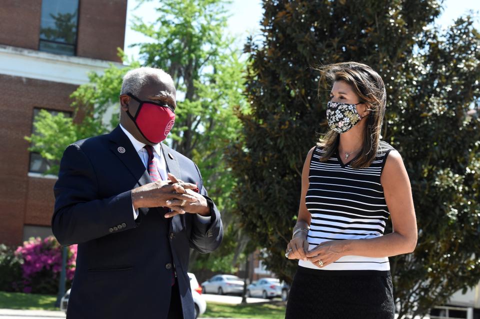 Former South Carolina Gov. Nikki Haley, right, stands with South Carolina State University President James Clark, left, during a tour of the HBCU's campus on Monday, April 12, 2021, in Orangeburg, S.C. Haley, often mentioned as a possible 2024 GOP presidential contender, said Monday that she would not seek her party's nomination if former President Donald Trump opts to run a second time. (AP Photo/Meg Kinnard)