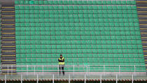 A steward looks on from an empty stand during the Serie A match between AC Milan and Genoa CFC which is being played in a closed stadium at Stadio Giuseppe Meazza on March 8, 2020 in Milan, Italy. (Photo by Marco Luzzani/Getty Images)