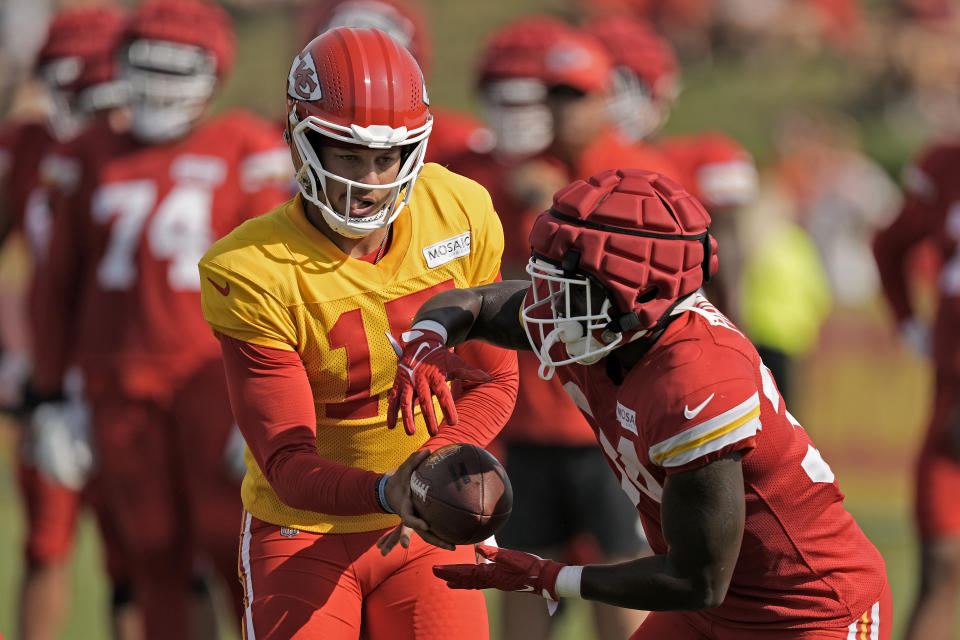Kansas City Chiefs quarterback Patrick Mahomes (15) hands the ball to running back Deneric Prince (34) during NFL football training camp Saturday, July 29, 2023, in St. Joseph, Mo. (AP Photo/Charlie Riedel)
