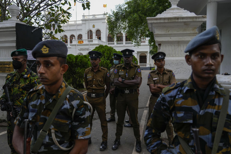 Army and police stand guard as protesters leave prime minister Ranil Wickremesinghe's office building in Colombo, Sri Lanka, Thursday, July 14, 2022. Sri Lankan protesters retreated from government buildings they seized and military troops reinforced security at the Parliament on Thursday, establishing a tenuous calm in a country in both economic meltdown and political limbo.(AP Photo/Rafiq Maqbool)
