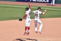 Jul 15, 2018; Cleveland, OH, USA; Cleveland Indians shortstop Francisco Lindor (12) and right fielder Tyler Naquin (30) celebrate a win over the New York Yankees at Progressive Field. Mandatory Credit: David Richard-USA TODAY Sports