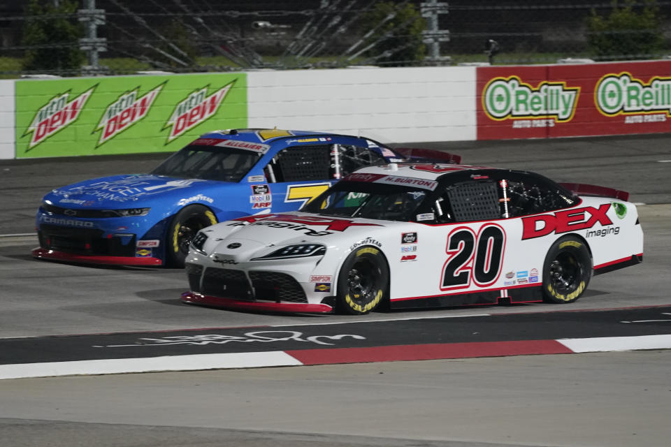 Harrison Burton (20) and Justin Allgaier (7) lead the field at the start of the NASCAR Xfinity Series auto race at Martinsville Speedway in Martinsville, Va., Friday, April 9, 2021. (AP Photo/Steve Helber)