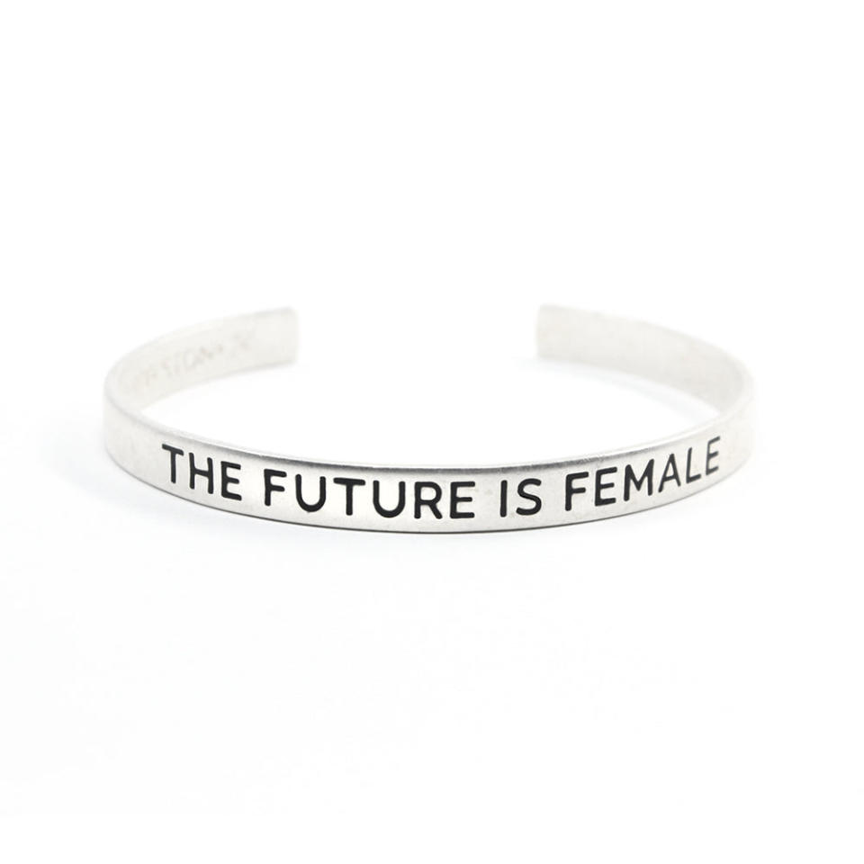 The Future is Female Cuff, $35, from Bird + Stone. Silver cuff with the words THE FUTURE IS FEMALE printed in black in capitals.