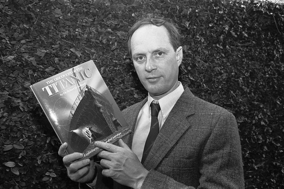 Robert Ballard holding up a book of the Titanic