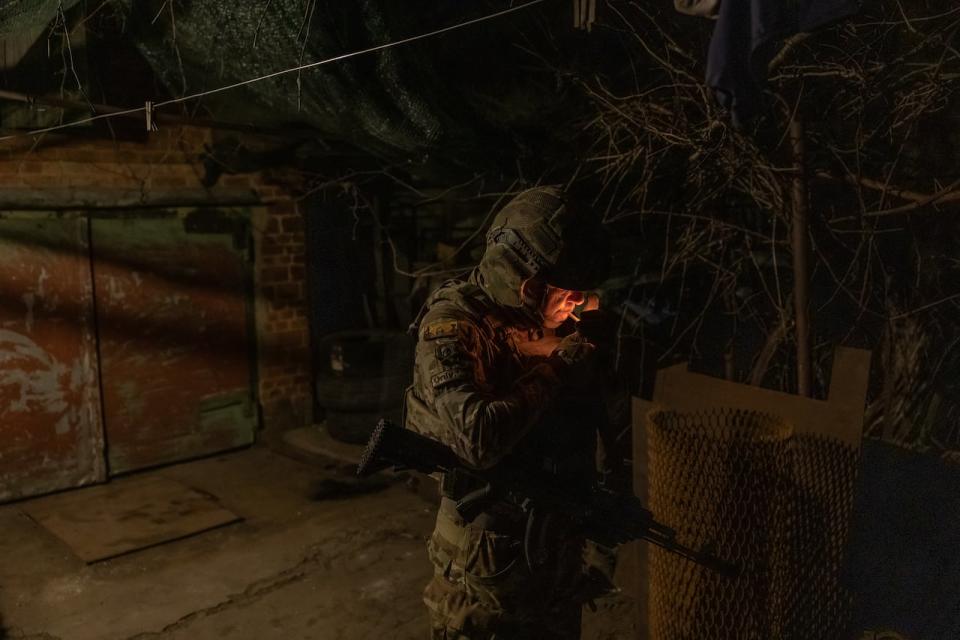 A Ukrainian soldier Anton, 40, from the 5th Assault Brigade smokes while waiting before heading for a 4-day rotation to the frontline, in an undisclosed area near the town of Chasiv Yar, Donetsk region, on March 28, 2024, amid the Russian invasion of Ukraine. The eastern city of Chasiv Yar is facing a "difficult and tense" situation, a Ukrainian army official said on March 25, 2024. If Russia took Chasiv Yar, it could step up attacks on the strategic city of Kramatorsk that is already facing growing bombardment.