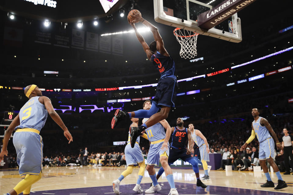 Five Lakers watch as Thunder forward Jerami Grant dunks uncontested. (AP)