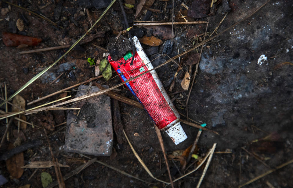 Used toothpaste of a deceased COVID-19 victim lies in a cremation ground in Gauhati, India, Friday, July 2, 2021. The personal belongings of cremated COVID-19 victims lie strewn around the grounds of the Ulubari cremation ground in Gauhati, the biggest city in India’s remote northeast. It's a fundamental change from the rites and traditions that surround death in the Hindu religion. And, perhaps, also reflects the grim fears grieving people shaken by the deaths of their loved ones — have of the virus in India, where more than 405,000 people have died. (AP Photo/Anupam Nath)