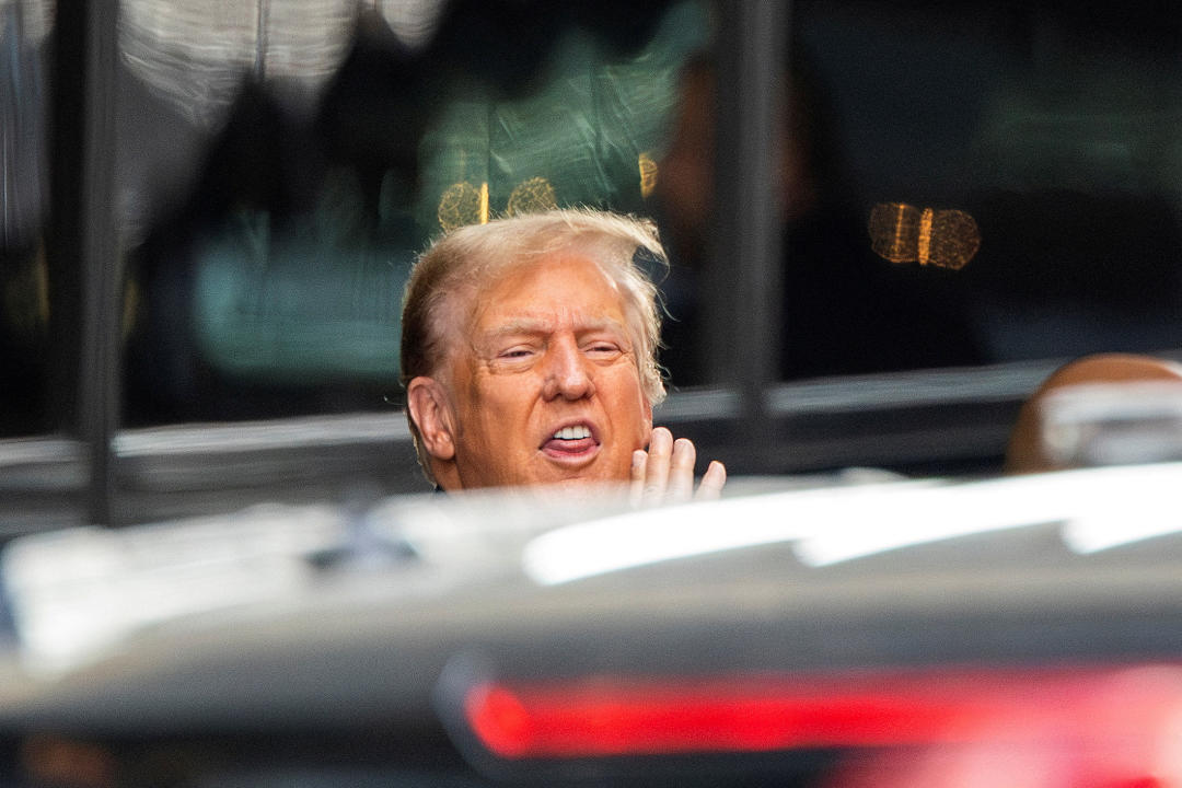 Former President Donald Trump screams to supporters as he exits Trump Tower.