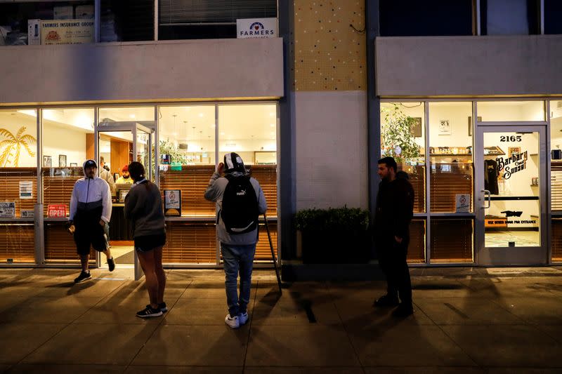 FILE PHOTO: People stand in line outside the Barbary Coast Sunset Cannabis Dispensary prior to the citywide shelter in place order amid the novel coronavirus (COVID-19) outbreak in San Francisco