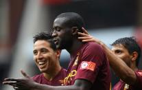 Manchester City's Gnegneri Toure Yaya (centre) is congratulated on scoring their first goal of the game
