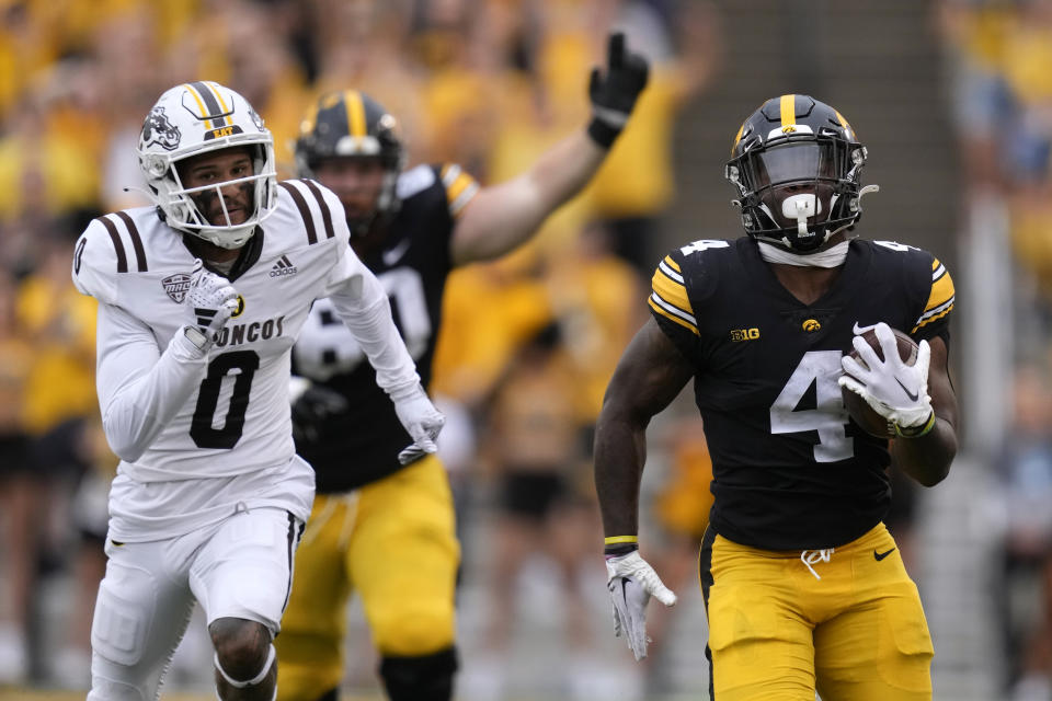 Iowa running back Leshon Williams (4) runs from Western Michigan cornerback DaShon Bussell (0) during the first half of an NCAA college football game, Saturday, Sept. 16, 2023, in Iowa City, Iowa. (AP Photo/Charlie Neibergall)