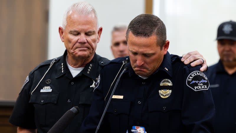 Salem Police Chief Brad James puts his arm around Santaquin Police Sgt. Mike Wall as he speaks emotionally during a press conference after a Santaquin police officer was hit by a vehicle and killed earlier Sunday, at Santaquin City Hall in Santaquin on Sunday, May 5, 2024.