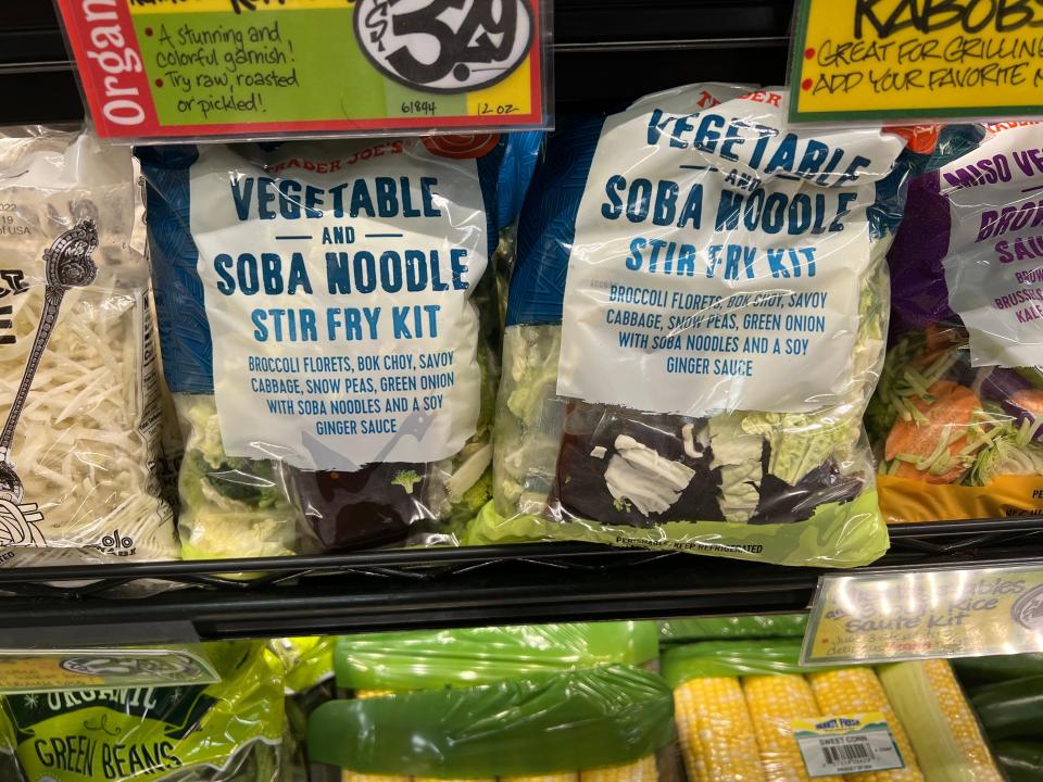 Bags of vegetable and soba noodle stir fry kit on a shelf at Trader Joe's