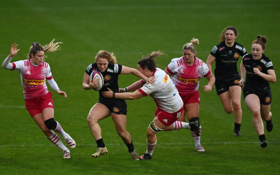 Jennine Detiveaux of Exeter Chiefs is tackled by Sarah Beckett of Harlequins during the Women's Allianz Premier 15s match between Exeter Chiefs Women and Harlequins Women at Sandy Park on January 16, 2022 in Exeter, England - GETTY IMAGES