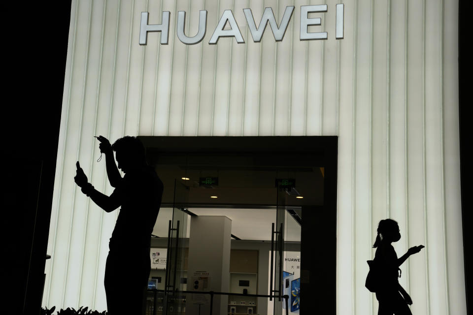 Visitors to a mall walk past a Huawei store in Beijing, China, on Aug. 26, 2021. Chips are a top priority in the ruling Communist Party's marathon campaign to end China's reliance on technology from the United States and official urgency over that grew after Huawei Technologies Ltd., China's first global tech brand, lost access to U.S. chips and other technology in 2018 under sanctions imposed by the White House. (AP Photo/Ng Han Guan)