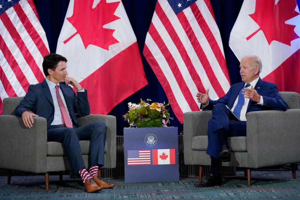 President Joe Biden, right, meets with Canadian Prime Minister Justin Trudeau during the Summit of the Americas, 9 June 2022, in Los Angeles (AP)