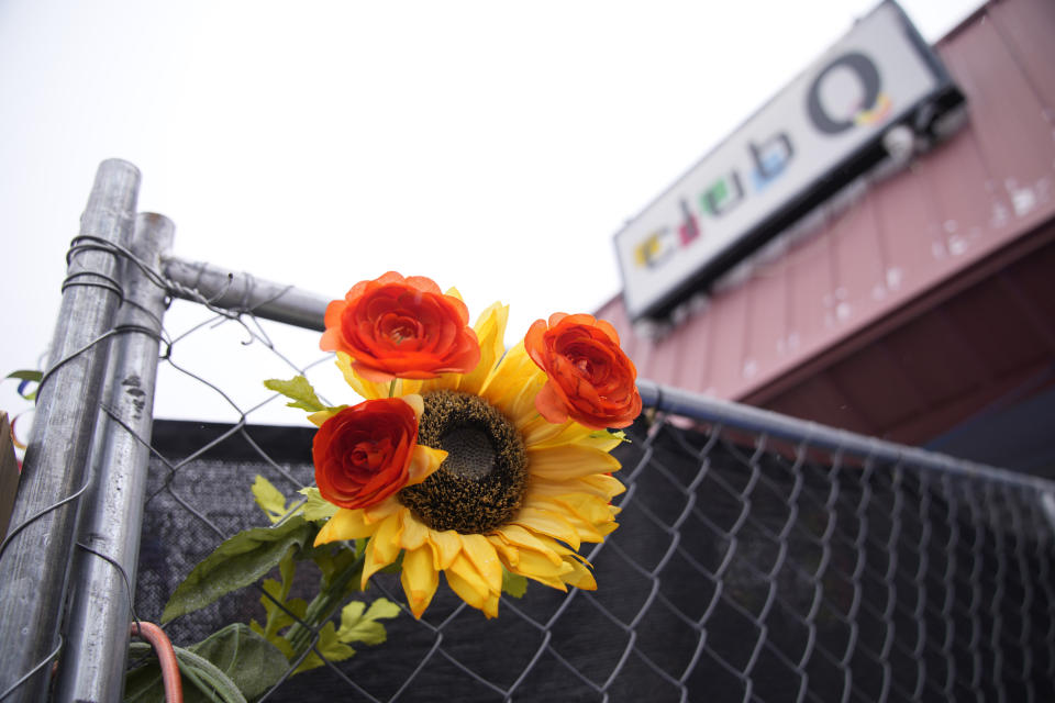A tribute is placed in a fence of Club Q, which was the site of a mass shooting in November 2022, Wednesday, Feb. 22, 2023, in Colorado Springs, Colo. A Navy sailor grabbed the barrel of a gunman’s rifle and an Army veteran rushed in to help as they ended the deadly mass shooting at the gay nightclub in November, a police detective testified Wednesday. (AP Photo/David Zalubowski)