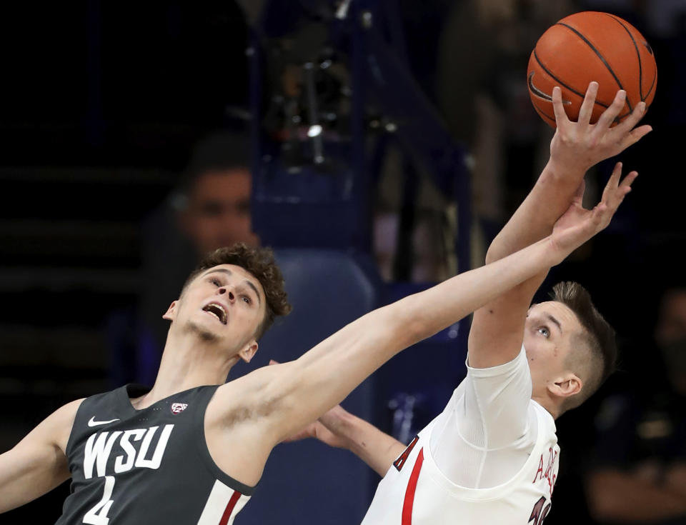 Washington State forward Aljaz Kunc (4) just misses coming down with a rebound, next to Arizona forward Azuolas Tubelis (10) during the first half of an NCAA college basketball game Thursday, Feb. 25, 2021, in Tucson, Ariz. (Kelly Presnell/Arizona Daily Star via AP)