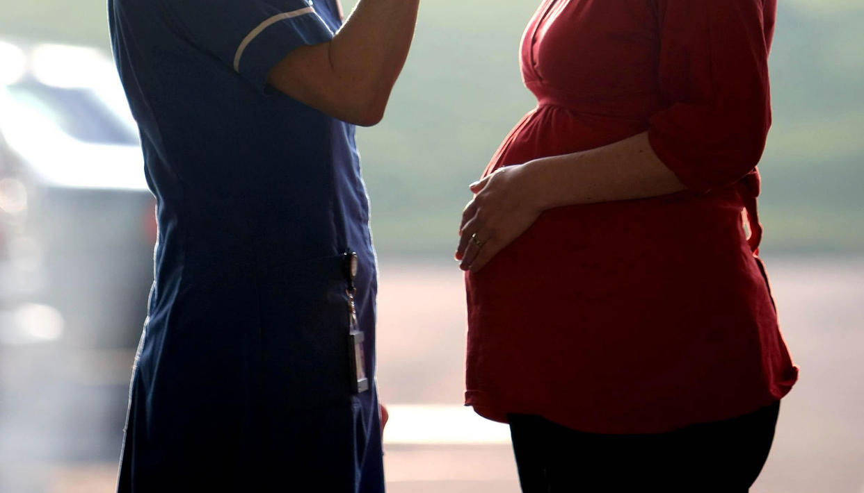 File photo dated 19/02/08 of a midwife talking to a pregnant woman as hospital chiefs have been accused of "burying their heads in the sand" over midwife shortages after figures suggested a quarter of NHS Trusts had not assessed their workforce needs for at least four years.