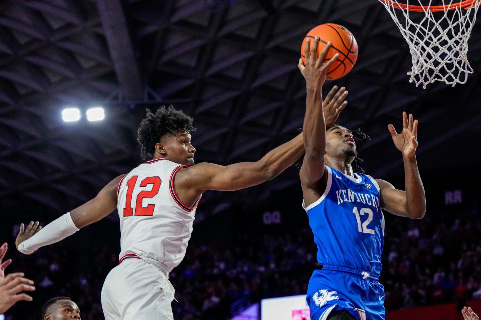 Feb 11, 2023; Athens, Georgia, USA; Kentucky Wildcats guard Antonio Reeves (12) goes to the basket behind Georgia Bulldogs forward Matthew-Alexander Moncrieffe (12) during the first half at Stegeman Coliseum. Mandatory Credit: Dale Zanine-USA TODAY Sports