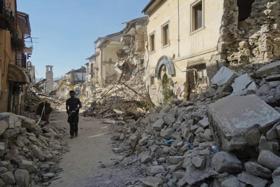 <p>A man walks in a street in Amatrice, central Italy, where a 6.1 earthquake struck just after 3:30 a.m., Wednesday, Aug. 24, 2016. (AP Photo/Emilio Fraile) </p>