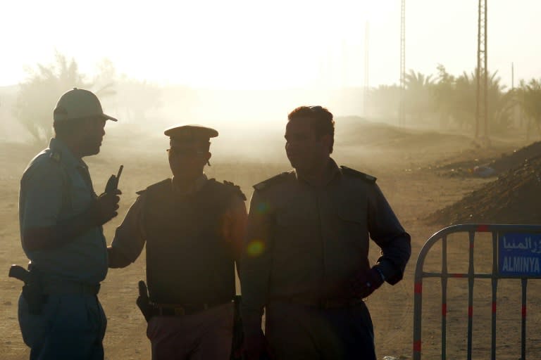 Egyptian policemen guard the road to Saint Samuel monastery in Minya province after the attack on a bus carrying Coptic Christians on May 26, 2017