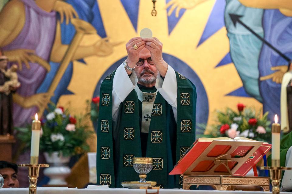 Archbishop Paul Coakley blesses the bread and wine Saturday, Feb. 11, at the last Saturday service at Holy Angels Church in Oklahoma City.