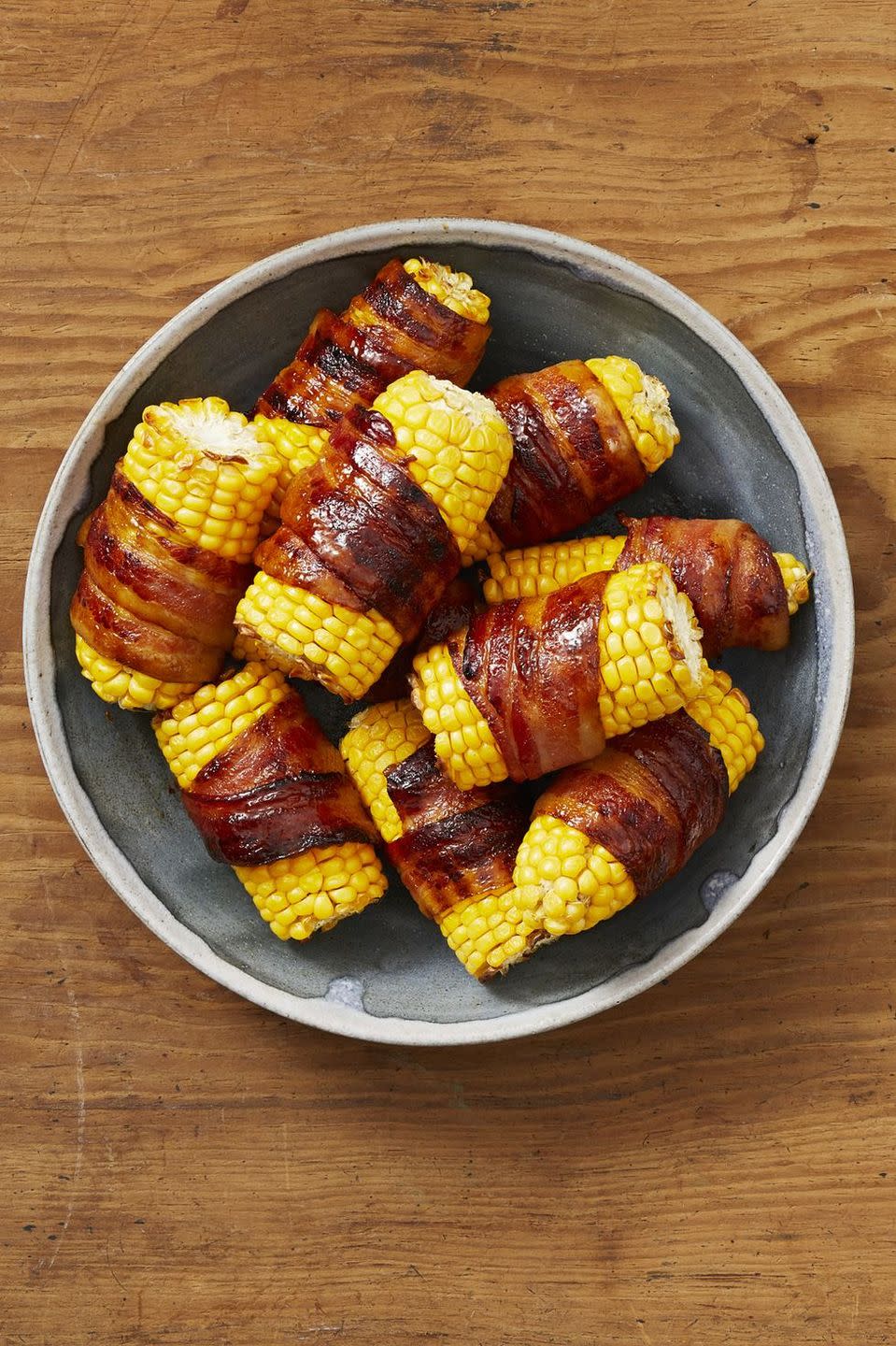 <p>Add a twist to your summer corn by wrapping it up in bacon. Each ear of corn is then brushed with a spicy honey that gives it an extra sweet and savory kick. </p><p><a href="https://www.thepioneerwoman.com/food-cooking/recipes/a32905619/bacon-wrapped-corn-on-the-cob-recipe/" rel="nofollow noopener" target="_blank" data-ylk="slk:Get Ree’s recipe.;elm:context_link;itc:0;sec:content-canvas" class="link "><strong>Get Ree’s recipe. </strong></a></p><p><a class="link " href="https://go.redirectingat.com?id=74968X1596630&url=https%3A%2F%2Fwww.walmart.com%2Fsearch%2F%3Fquery%3Dbasting%2Bbrushes&sref=https%3A%2F%2Fwww.thepioneerwoman.com%2Ffood-cooking%2Fmeals-menus%2Fg36353420%2Ffourth-of-july-side-dishes%2F" rel="nofollow noopener" target="_blank" data-ylk="slk:SHOP BASTING BRUSHES;elm:context_link;itc:0;sec:content-canvas">SHOP BASTING BRUSHES</a></p>