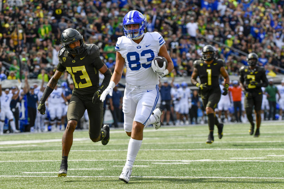 BYU tight end Isaac Rex (83) is chased by Oregon defensive back Bryan Addison (13) as he heads to the end zone during the first half of an NCAA college football game, Saturday, Sept. 17, 2022, in Eugene, Ore. (AP Photo/Andy Nelson)