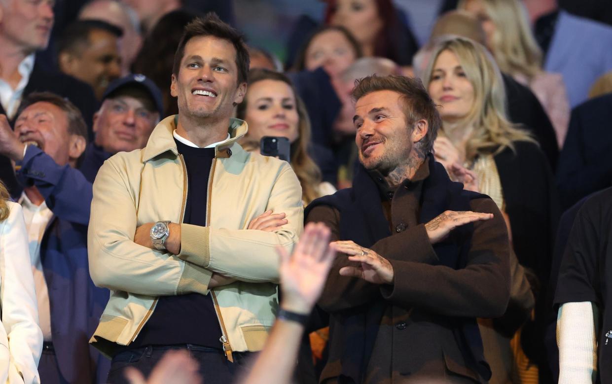 Tom Brady and David Beckham watch on