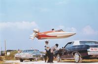 <p>Stunt performer Jerry Comeaux jumps a Glaston GT-50 speedboat over police officers and their squads as part of an escape scene from <em>Live and Let Die.</em></p>