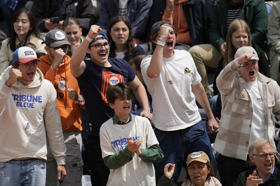 Spectators shout during the French Open tennis tournament at the Roland Garros stadium in Paris, Thursday, May 30, 2024. (AP Photo/Thibault Camus)