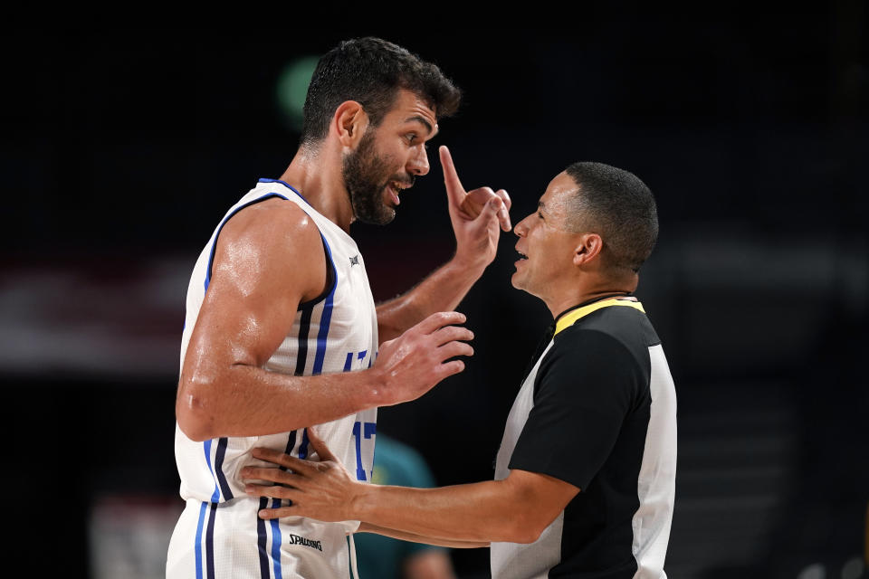 Italy's Giampaolo Ricci (17) questions a foul call during a men's basketball preliminary round game against Australia at the 2020 Summer Olympics, Wednesday, July 28, 2021, in Saitama, Japan. (AP Photo/Charlie Neibergall)