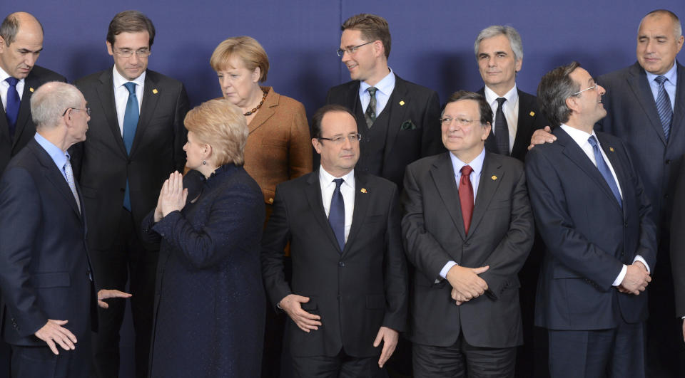 Front row left to right, European Council President Herman Van Rompuy, Lithuanian President Dalia Grybauskaite, French President Francois Hollande, European Commission President Jose Manuel Barroso and Greek Prime Minister Antonis Samaras. Back row left to right, Slovenian Prime Minister Janez Jansa, Portugal's Prime Minister Pedro Passos Coelho, German Chancellor Angela Merkel, Finland's Prime Minister Jyrki Tapani Katainen, Austria's Chancellor Werner Faymann and Bulgaria's Prime Minister Boyko Borissov pose during a group photo at an EU summit in Brussels on Friday, Nov. 23, 2012. EU leaders begin what is expected to be a marathon summit on the budget for the years 2014-2020. The meeting could last through Saturday and break up with no result and lots of finger-pointing. (AP Photo/Geert Vanden Wijngaert)