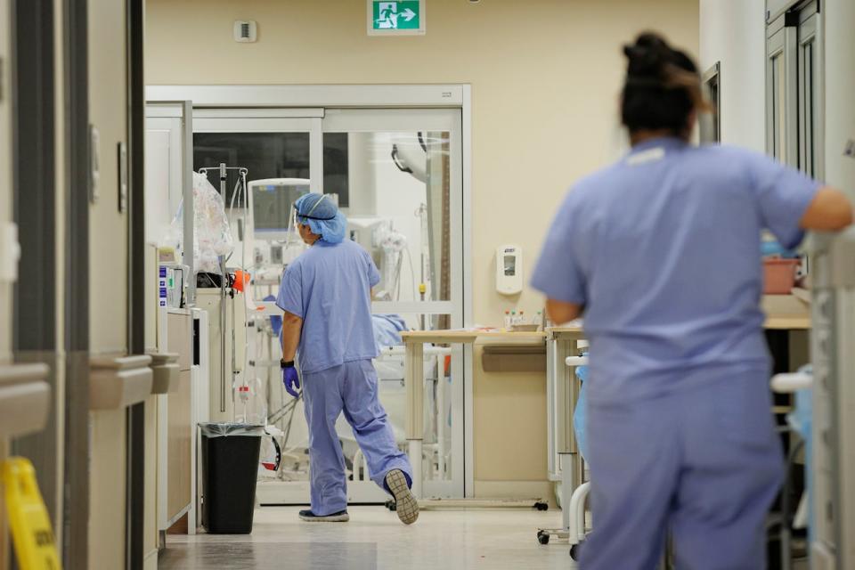 A nurse walks towards a patient in the emergency department of Humber River Hospital, in Toronto, on Jan. 25, 2022.