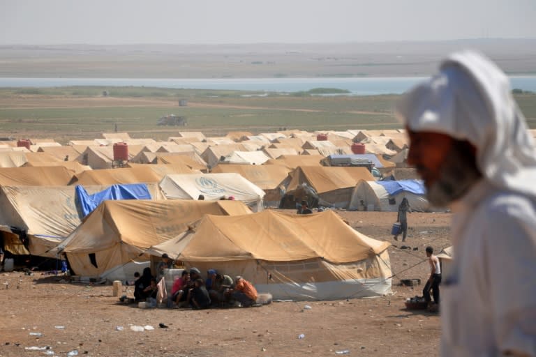 Displaced Syrians are seen on August 13, 2017 at a desert camp in Hasakeh province dominated by young men fleeing Islamic State group conscription