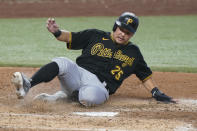 Pittsburgh Pirates' Yoshi Tsutsugo of Japan, slides into home plate to score on a fielding error by Miami Marlins third baseman Brian Anderson during the eighth inning of a baseball game, Thursday, July 14, 2022, in Miami. (AP Photo/Wilfredo Lee)