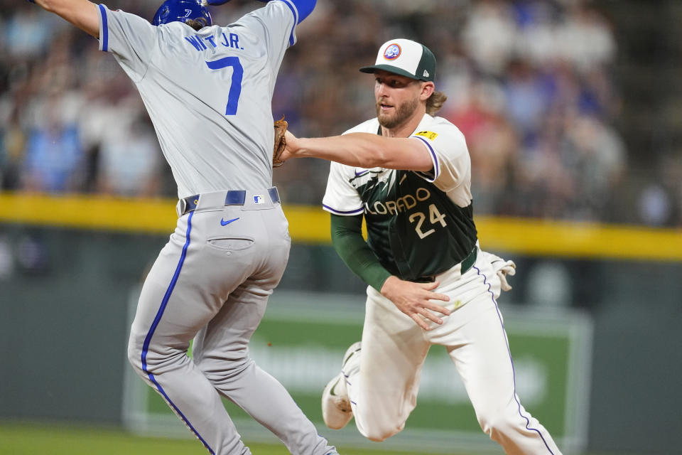 Colorado Rockies third baseman Ryan McMahon, right, tags out Kansas City Royals' Bobby Witt Jr. after he was caught in a rundown between first and second bases in the eighth inning of a baseball game Saturday, July 6, 2024, in Denver. (AP Photo/David Zalubowski)