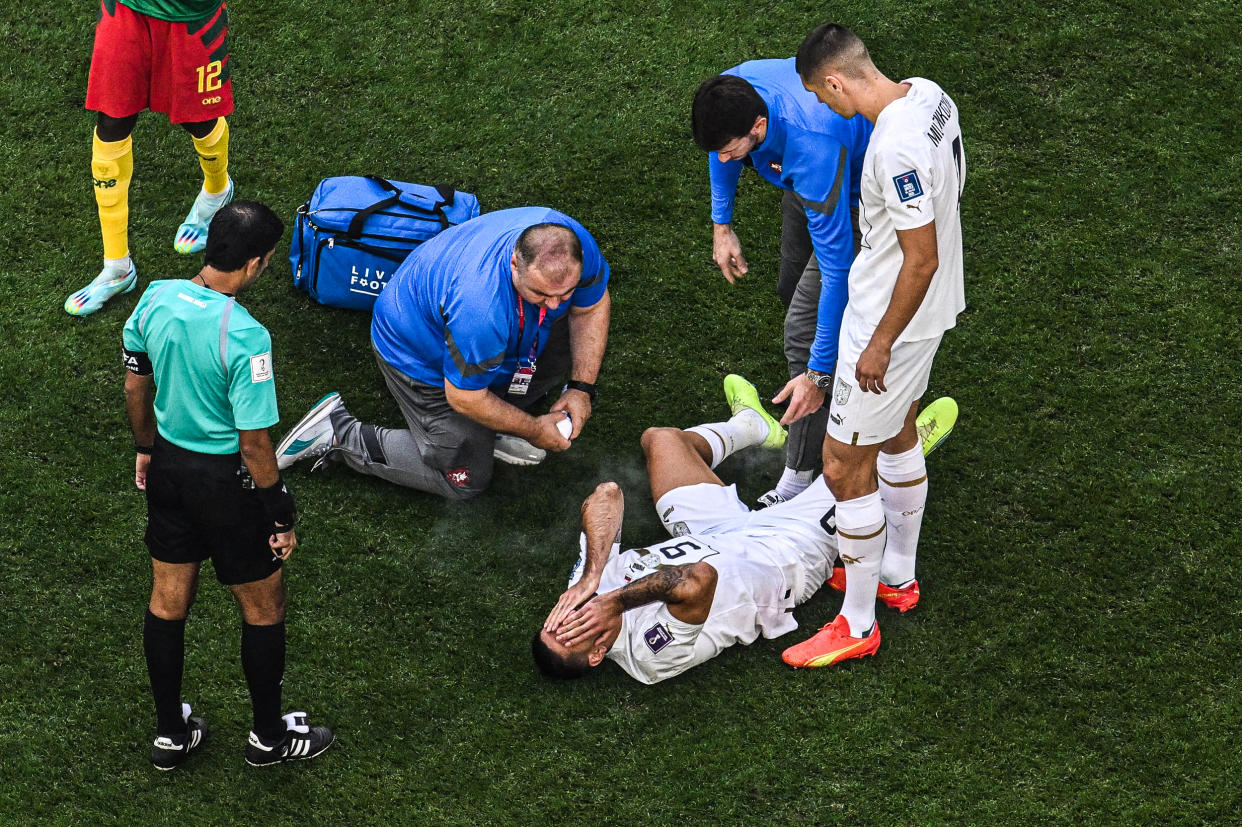 Image: Serbia's forward #09 Aleksandar Mitrovic receives medical attention during the Qatar 2022 World Cup Group G football match between Cameroon and Serbia at the Al-Janoub Stadium in Al-Wakrah, south of Doha on Nov. 28, 2022. (Antonin Thuillier / AFP - Getty Images)