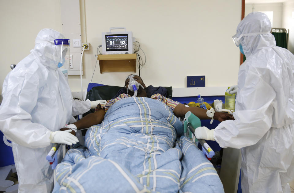 Medical staff wearing protective equipment attend to patients affected by the COVID-19, at the Intensive Care Unit (ICU) of the Machakos County Level-5 hospital in Machakos, Kenya, Thursday June 17, 2021. Africa, whose 1.3 billion people account for 18% of the global population, has received only 2% of all vaccine doses administered globally. (AP Photo/Brian Inganga).