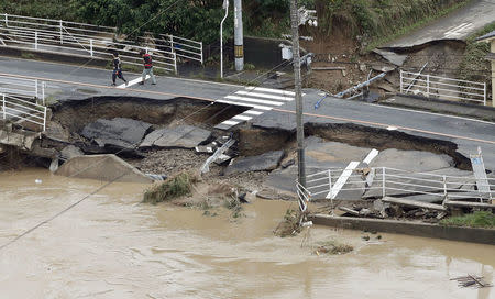 A broken road is seen after heavy rain in Kurashiki, Okayama Prefecture, Japan, in this photo taken by Kyodo July 8, 2018. Mandatory credit Kyodo/via REUTERS