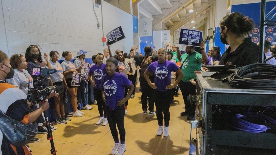 Students perform in the wing of James Brown Arena at the start of a campaign rally for Democratic gubernatorial candidate Stacey Abrams.